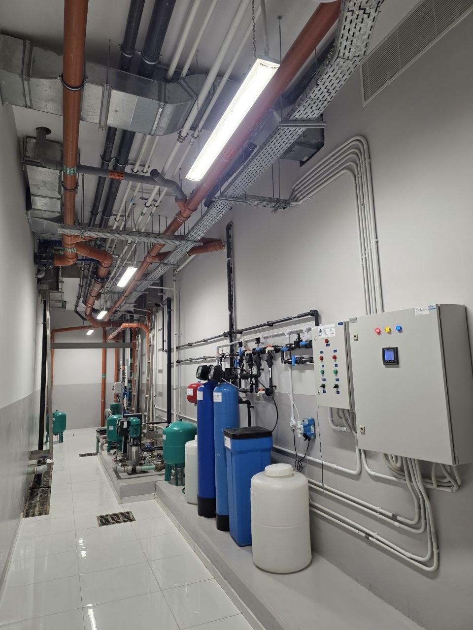 Water treatment and booster pumping in services corridor — Villa Fawaz